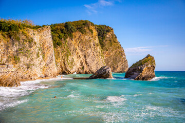 The beach and the cliffs on the island of St. Nicholas in Budva, Montenegro. Paradise beach on an island in the sea