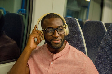 Portrait of man with headphones in train © Cultura Creative
