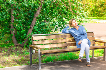 A woman catches the last warm days and the sun's rays at the end of summer before the arrival of...