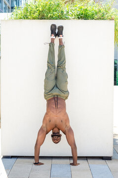 Mid adult man doing handstand