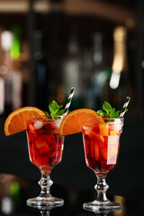 Delicious sangria cocktail on black table in bar. Space for text
