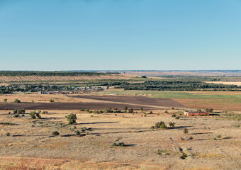 landscape with a village in a field from the top of a hill