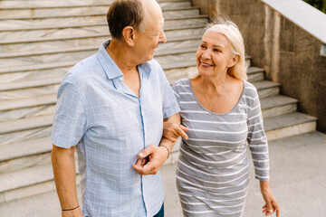 Smiling senior couple walking outdoors