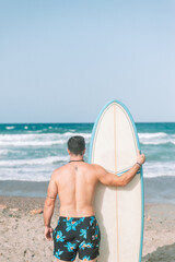Naklejka na ściany i meble Surf beach fun surfer man. Surfing in Spain. Young sport athlete