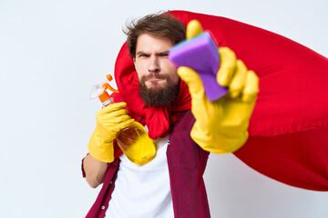 man superhero in red cloak cleaning supplies professional