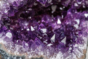 Macro Mineral Stone Amethysts in the rock on a white background