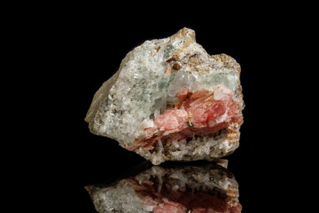 Macro of the mineral stone Rhodochrosite with fluorite on a black background