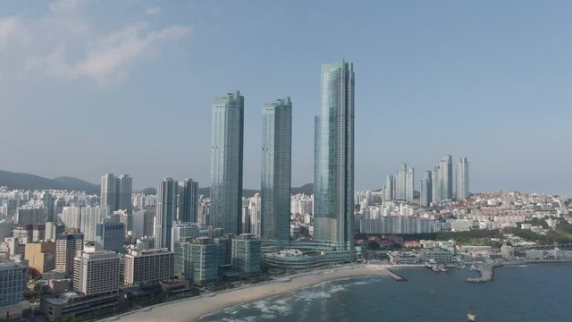 Aerial view of Haeundae beach in the Busan. Skyscraper and Haeundae beach. May, 2021. 부산, 초고층빌딩, 해운대 해수욕장.