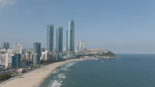 Aerial view of Haeundae beach in the Busan. Skyscraper and Haeundae beach. May, 2021. 부산, 초고층빌딩, 해운대 해수욕장.
