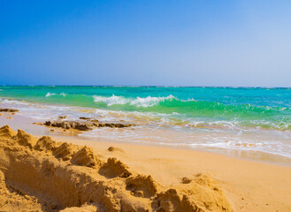Sand castles against the turquoise water of the sea. Marsa Alam, Egypt, Red Sea