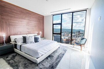 Modern and contemporary bedroom with white ceiling and wood accents with views of Oslo skyline....