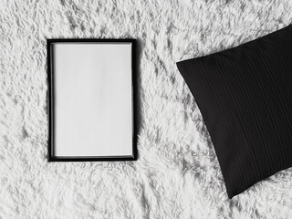 Thin wooden frame with blank copyspace as poster photo print mockup, black cushion pillow and...