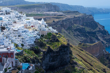 Panoramic view of Oia town cityscape at Santorini island in Greece. Traditional white houses....