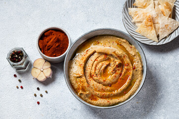 Traditional arabian eggplant dip baba ganoush with herbs and smoked paprika on light background. Eggplant hummus. Babaganush or eggplant caviar. Baked eggplant. Turkish eggplant dip