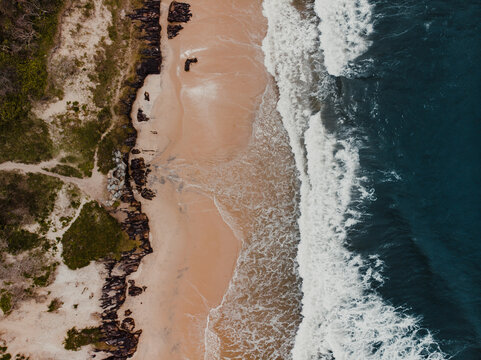 Drone Shot Of Waves Crashing On A Beach From Above