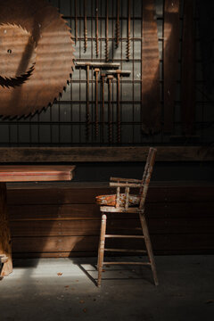 Old vintage wooden chair with industrial timber mill background