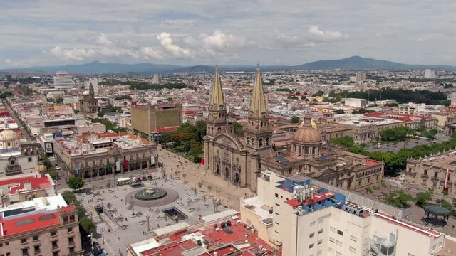 Guadalajara Cathedral With Pedestrians Walking At Plaza Guadalajara In The Foreground In Jalisco, Mexico. - aerial, NE side view