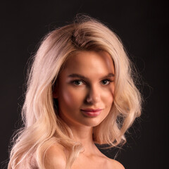 Naklejka premium portrait for avatar of a young blonde girl on a dark background