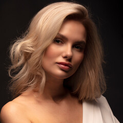 Fototapeta premium portrait for avatar of a young blonde girl on a dark background