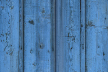Natural pattern and texture of rough and old wood planks surface dyed with blue color.