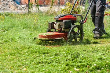 Mowing the grass with a lawn mower