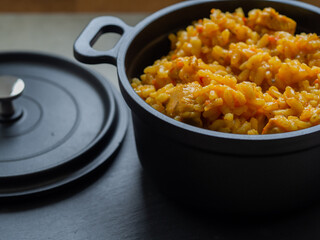 Paella - a Spanish dish originating in Valencia and occurring in many varieties. It is based primarily on rice with the addition of saffron, fried and cooked in a metal pan with two handles.