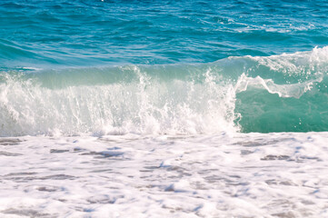 beautiful surf waves near the sandy beach on a clear summer da?