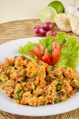 shrimp or prawn with salted egg sauce plated on a white plate and ingredients
