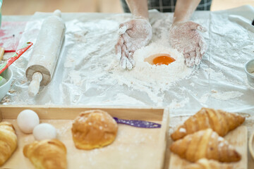 Fototapeta na wymiar Duck egg in the flour powder for bakery bread in kitchen