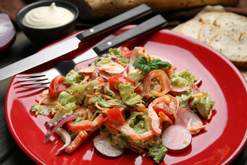 Delicious salad with mayonnaise served on table, closeup