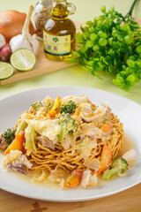 Ifumi is an Indonesian crispy deep fried thick noodle dish, popular in Maritime Southeast Asia, served in a thick savoury sauce with pieces of meat or seafood and vegetables.