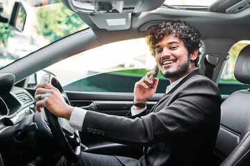 Curly-haired businessman talking on the phone