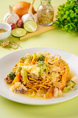 Ifumi is an Indonesian crispy deep fried thick noodle dish, popular in Maritime Southeast Asia, served in a thick savoury sauce with pieces of meat or seafood and vegetables.