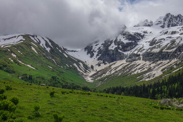Fototapeta na wymiar Mountain Ridge of Caucasian Range Partly Covered with Snow