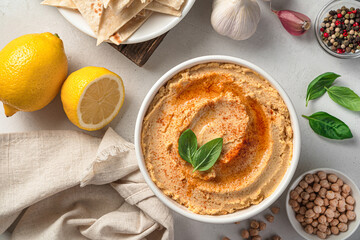 Traditional hummus with olive oil and paprika on a light background. Oriental appetizer. Healthy, vegetarian food.