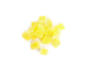 Delicious yellow candied fruit pieces on white background, top view
