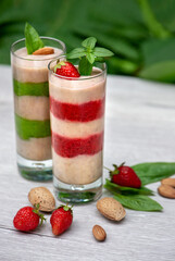 Strawberry and spinach matcha banana smoothie with vegetable milk and almonds, selective focus. Healthy, low-calorie and low-carb healthy food. Healthy eating, nutrition and diet concept
