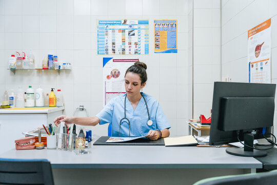 Veterinarian taking supplies while working at table in clinic