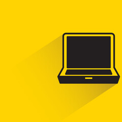 laptop computer with shadow on yellow background