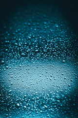 water droplets on glass. close-up. macro plan. blue background.