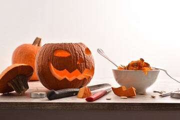Freshly carved hallowen squash on the table isolated white