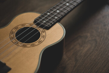 Obraz premium guitar ukulele on wooden background. close-up, macro.
