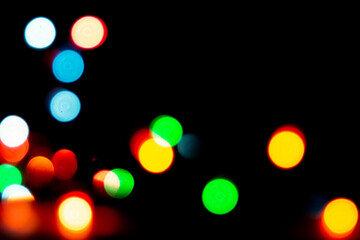 blurred defocused christmas lights bokeh on a black background
