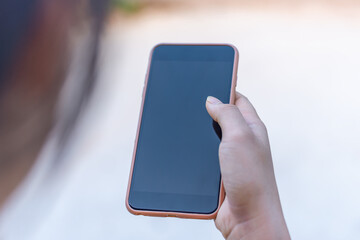 Hand with smart phone black screen blurred