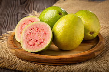 Fresh sliced ​​guavas on wooden table.