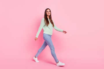 Full size profile side photo of young cheerful woman happy positive smile go walk meeting isolated over pink color background