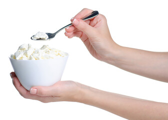 Hand holding cottage cheese in bowl with spoon on white background isolation