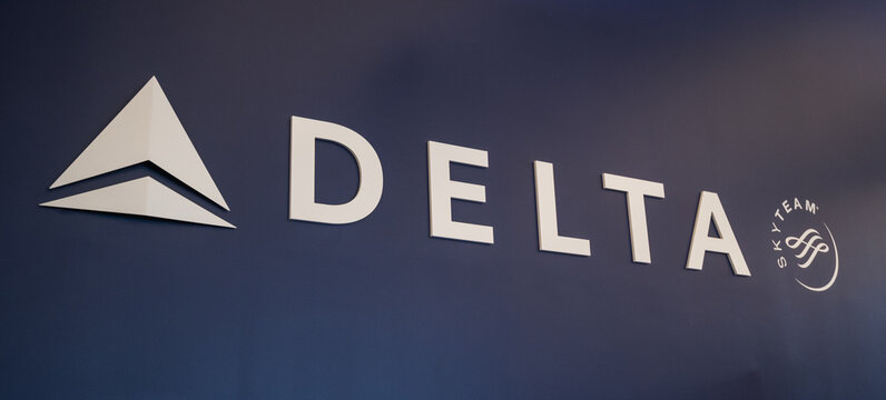 BOSTON, MASSACHUSETTS - AUGUST 11, 2021: Delta Sky Team logo and branding with blue background in the Boston Logan Airport.