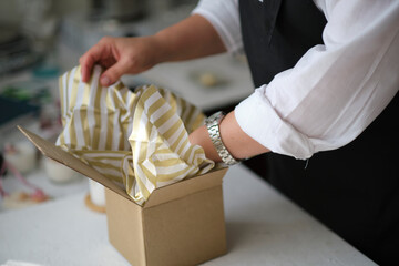 small business owner, online marketing packaging box and delivery. A parcel wrapped in brown paper....