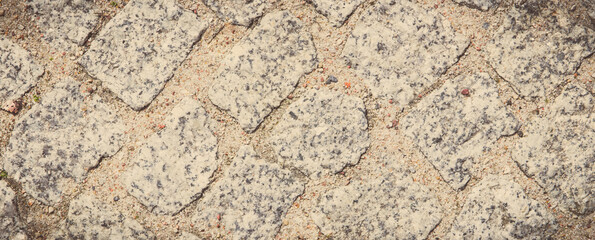 Footpath made of rocks or stones. Background texture. Vintage photo